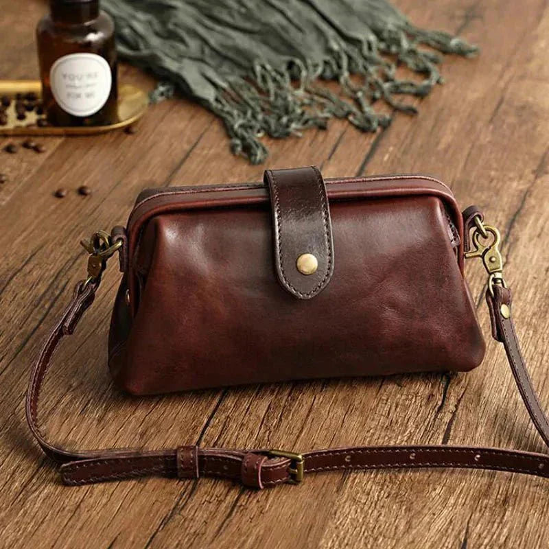 Eclipse Charm refined leather shoulder bag with vintage-inspired frame closure and copper clasp