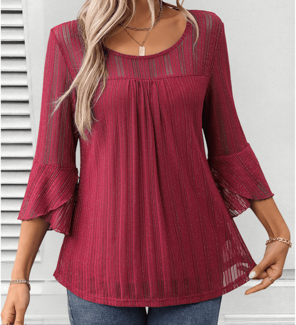 Larra sleek pleated blouse with bell sleeves and subtle shimmer, shown in a flowing silhouette