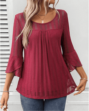 Larra sleek pleated blouse with bell sleeves and subtle shimmer, shown in a flowing silhouette