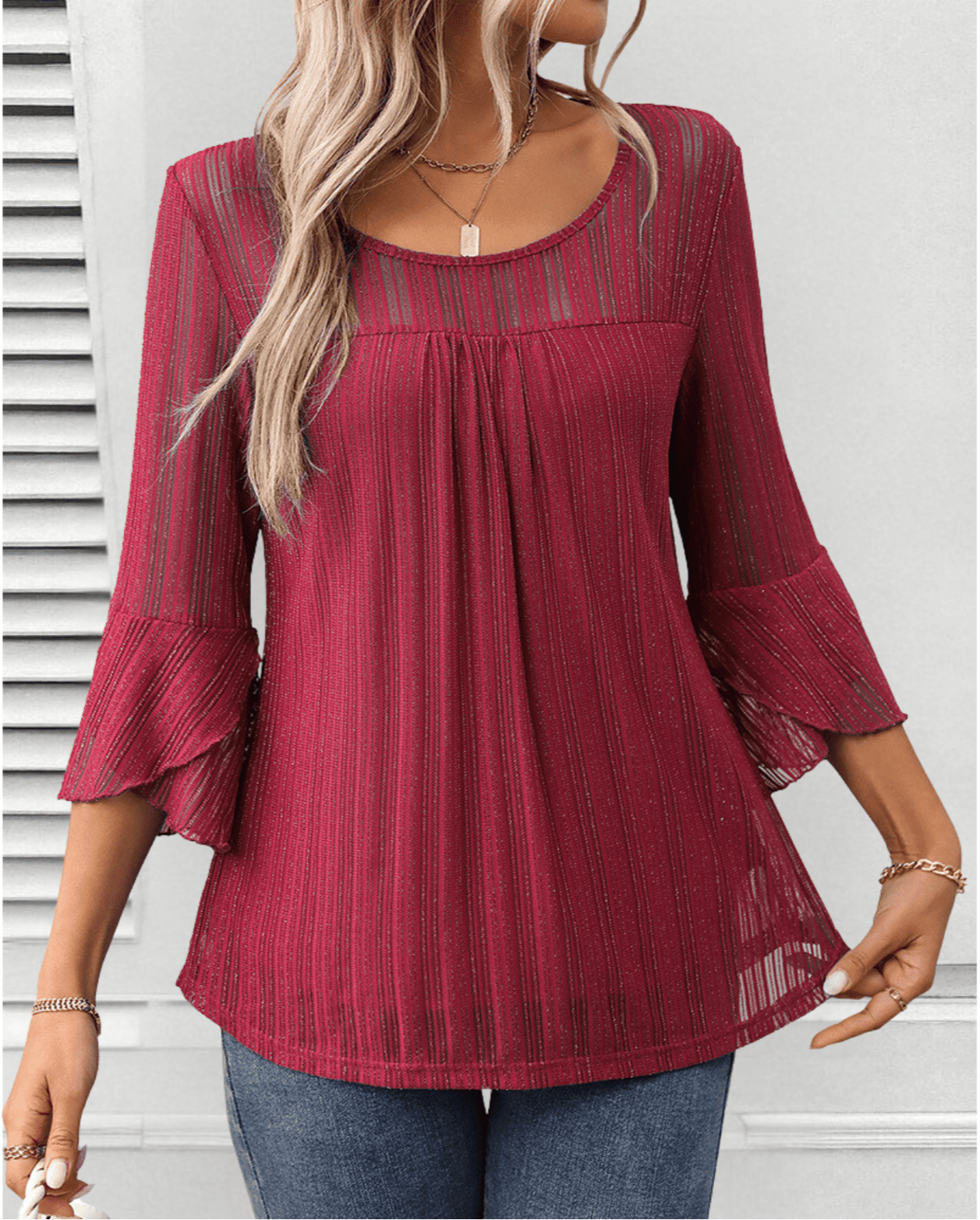 Larra sleek pleated blouse with bell sleeves and subtle shimmer, shown in a flowing silhouette