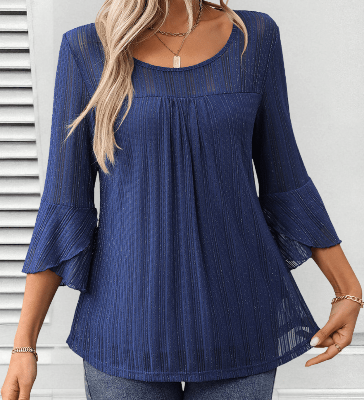 Larra sleek pleated blouse with bell sleeves and subtle shimmer, shown in a flowing silhouette