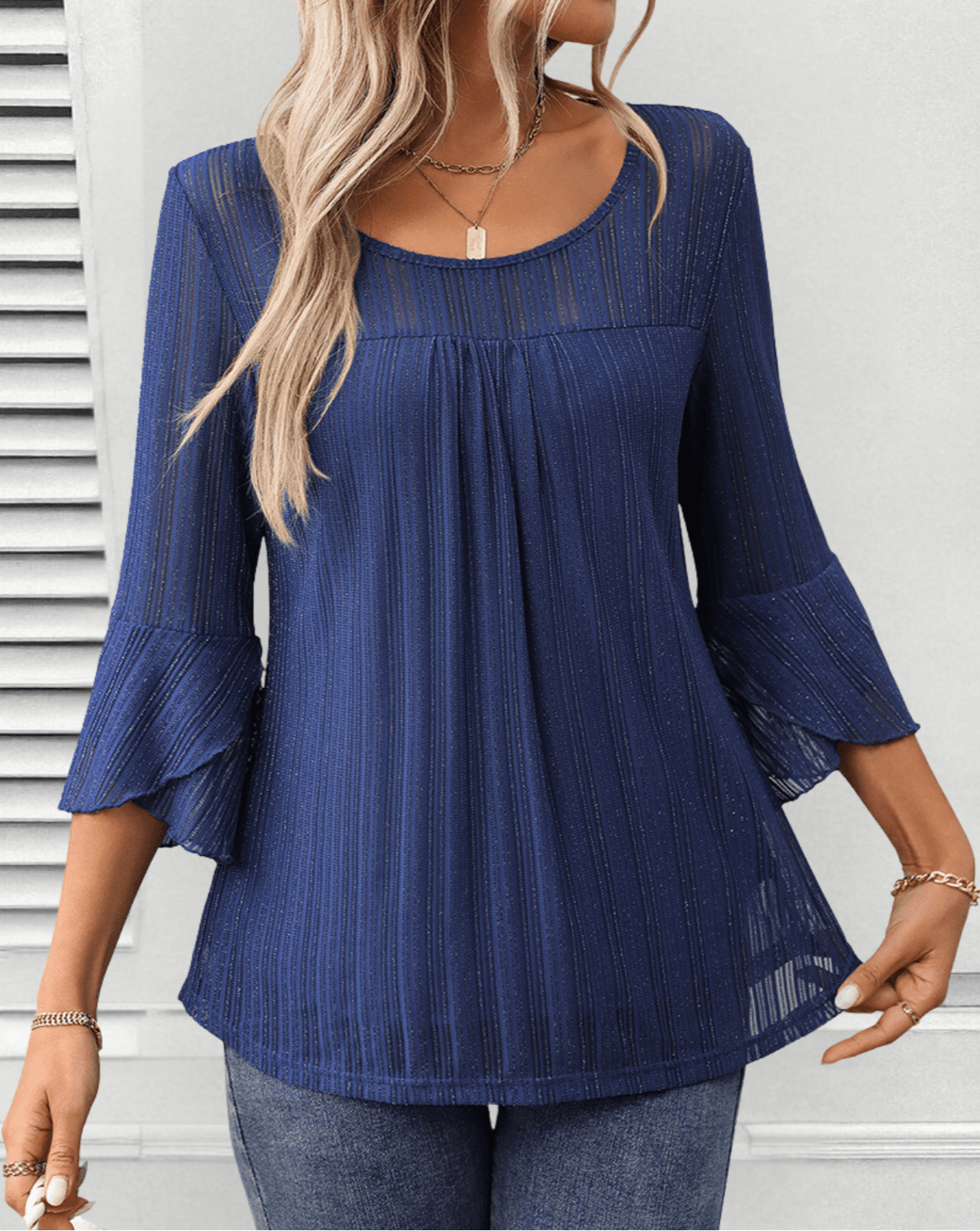 Larra sleek pleated blouse with bell sleeves and subtle shimmer, shown in a flowing silhouette