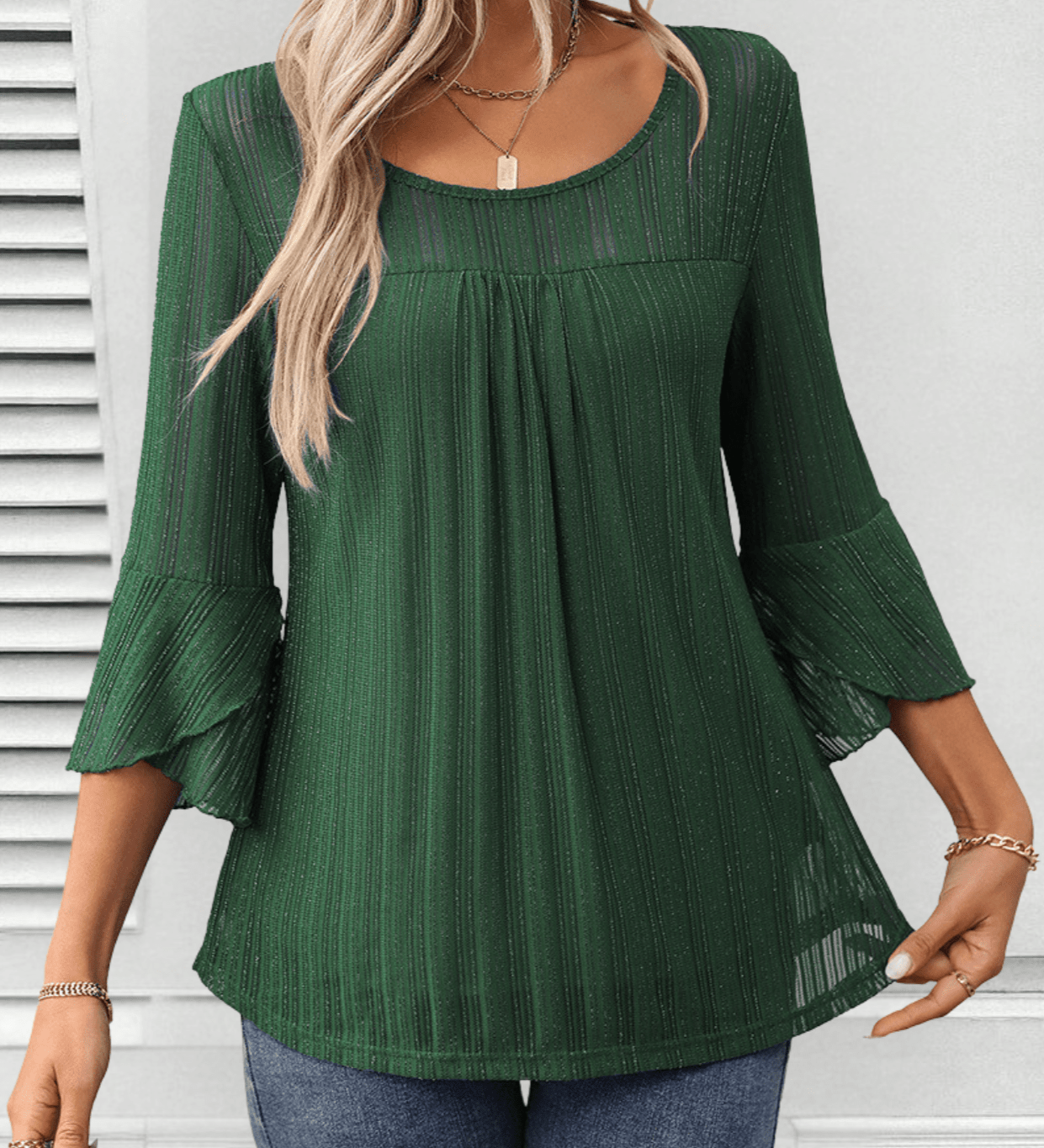Larra sleek pleated blouse with bell sleeves and subtle shimmer, shown in a flowing silhouette
