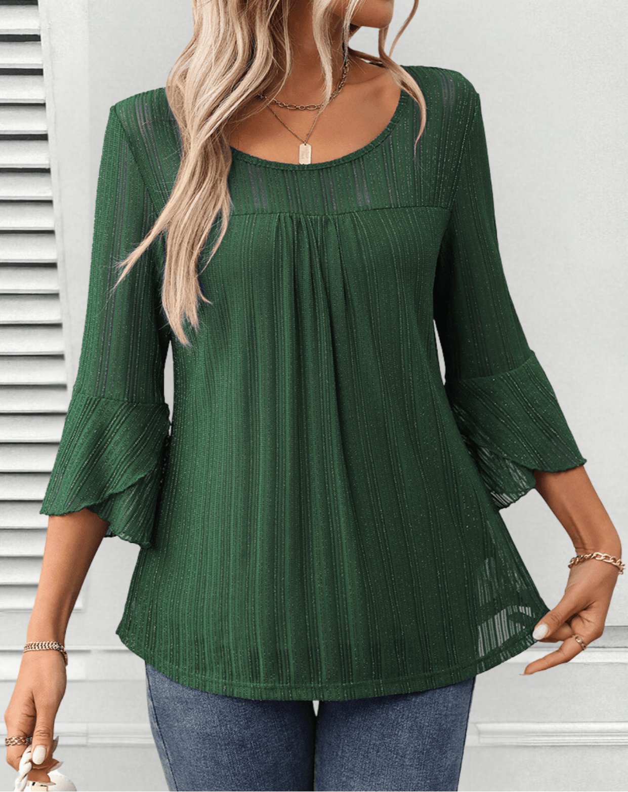 Larra sleek pleated blouse with bell sleeves and subtle shimmer, shown in a flowing silhouette