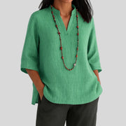 Elira chic everyday blouse with split V-neckline, three-quarter sleeves and peplum hem