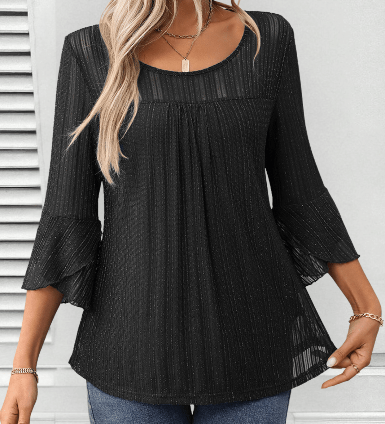 Larra sleek pleated blouse with bell sleeves and subtle shimmer, shown in a flowing silhouette