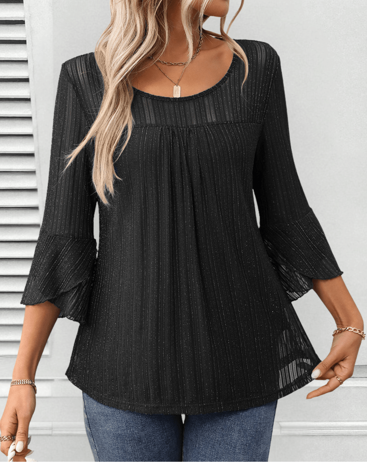Larra sleek pleated blouse with bell sleeves and subtle shimmer, shown in a flowing silhouette