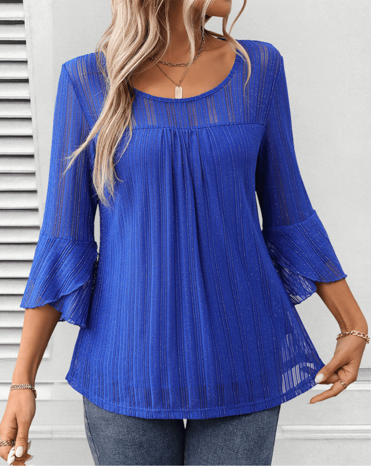 Larra sleek pleated blouse with bell sleeves and subtle shimmer, shown in a flowing silhouette