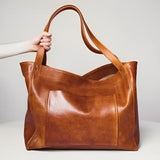 Sunset Luxe leather shoulder bag shown in brown, wine and black