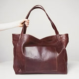 Sunset Luxe leather shoulder bag shown in brown, wine and black