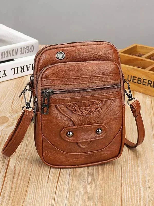 Celeste compact chic crossbody bag with adjustable strap in brown and black