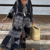 Emy black V-neck dress with elegant bell sleeves and soft flowy drape