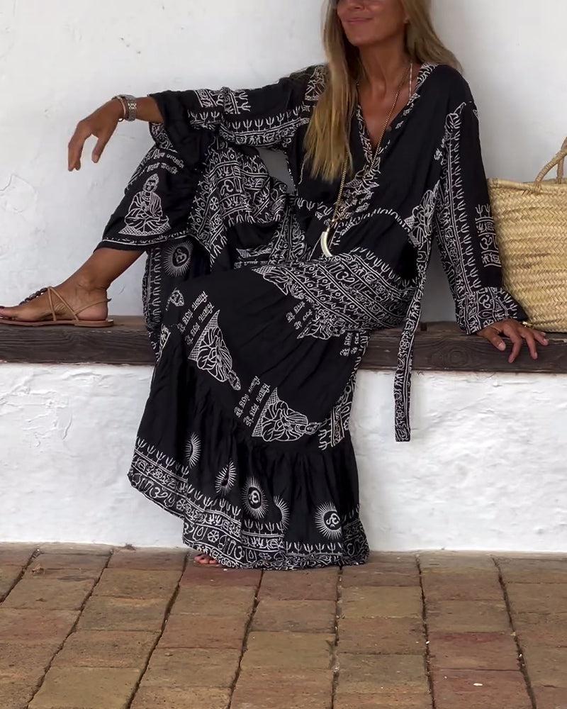 Emy black V-neck dress with elegant bell sleeves and soft flowy drape