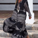 Emy black V-neck dress with elegant bell sleeves and soft flowy drape