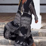 Emy black V-neck dress with elegant bell sleeves and soft flowy drape