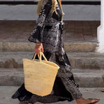 Emy black V-neck dress with elegant bell sleeves and soft flowy drape