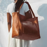Sunset Luxe leather shoulder bag shown in brown, wine and black