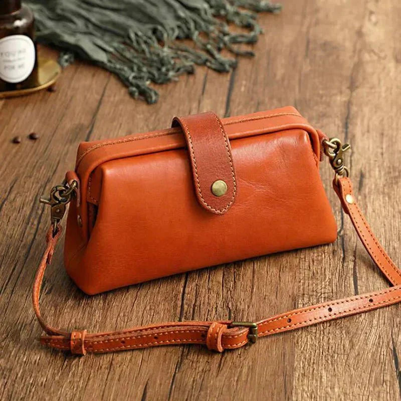 Eclipse Charm refined leather shoulder bag with vintage-inspired frame closure and copper clasp