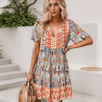 Abigail graceful midi dress shown in orange, available in pink and blue