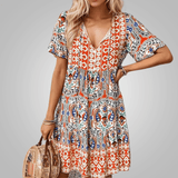 Abigail graceful midi dress shown in orange, available in pink and blue