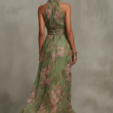Green floral halter maxi dress with defined waist and flowing skirt