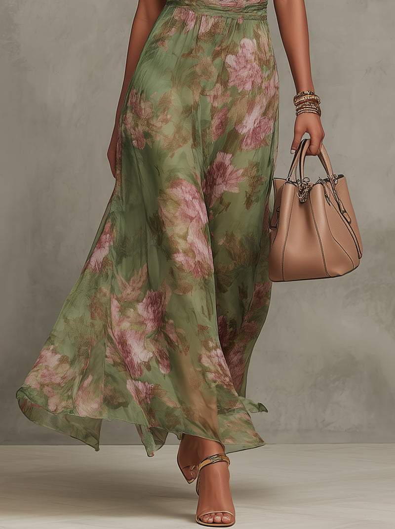 Green floral halter maxi dress with defined waist and flowing skirt