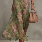 Green floral halter maxi dress with defined waist and flowing skirt
