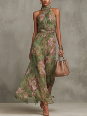 Green floral halter maxi dress with defined waist and flowing skirt