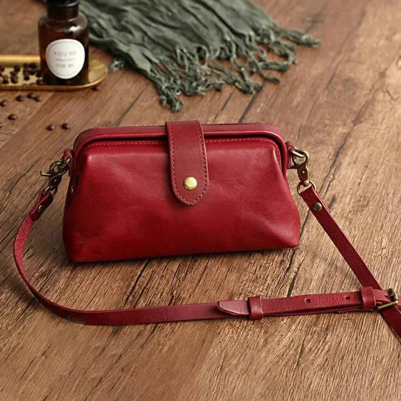 Eclipse Charm refined leather shoulder bag with vintage-inspired frame closure and copper clasp