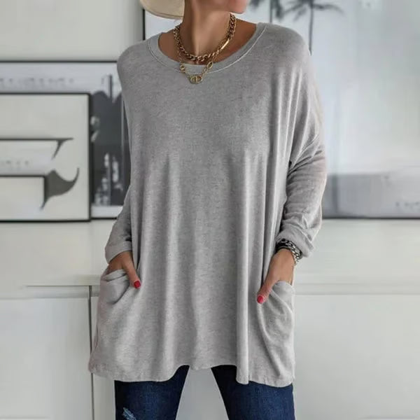 Alondra everyday pocket top with loose fit and flared hem, shown in a neutral colour