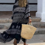 Emy black V-neck dress with elegant bell sleeves and soft flowy drape