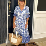 Keisha graceful V-neck floral dress shown in a soft feminine silhouette