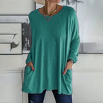 Alondra everyday pocket top with loose fit and flared hem, shown in a neutral colour