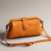 Eclipse Charm refined leather shoulder bag with vintage-inspired frame closure and copper clasp