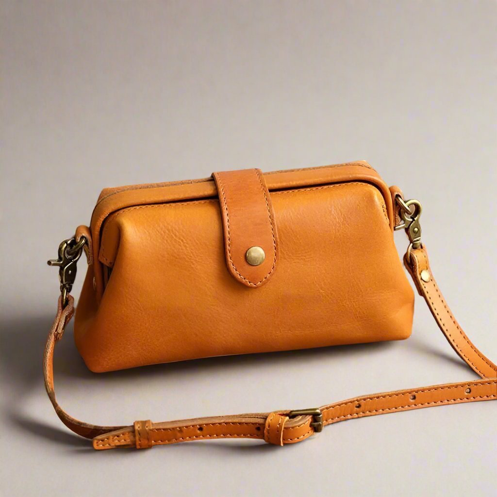 Eclipse Charm refined leather shoulder bag with vintage-inspired frame closure and copper clasp