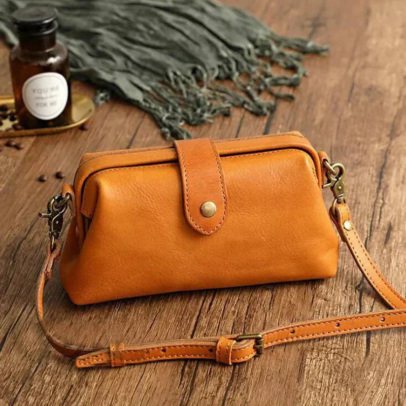 Eclipse Charm refined leather shoulder bag with vintage-inspired frame closure and copper clasp
