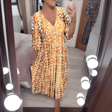 Amara boho chic printed dress in a bold flowing print, shown on a model
