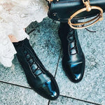 Andrea heeled boots shown in black and brown with a sleek modern silhouette