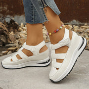 Isadora closed-toe sneaker sandals shown in carbon black and soft white
