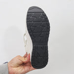 Isadora closed-toe sneaker sandals shown in carbon black and soft white