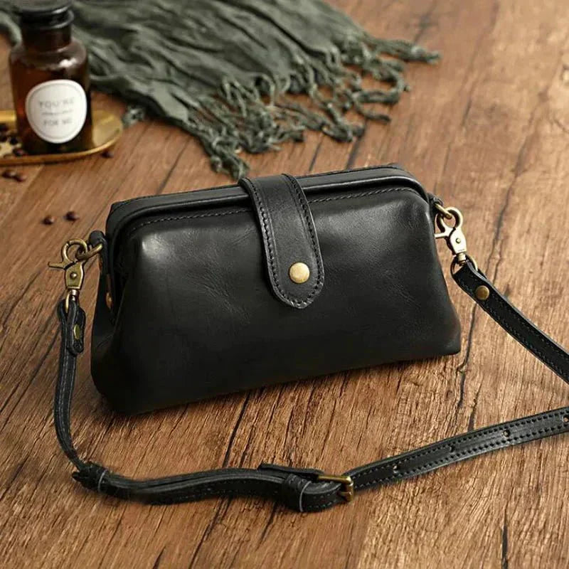 Eclipse Charm refined leather shoulder bag with vintage-inspired frame closure and copper clasp