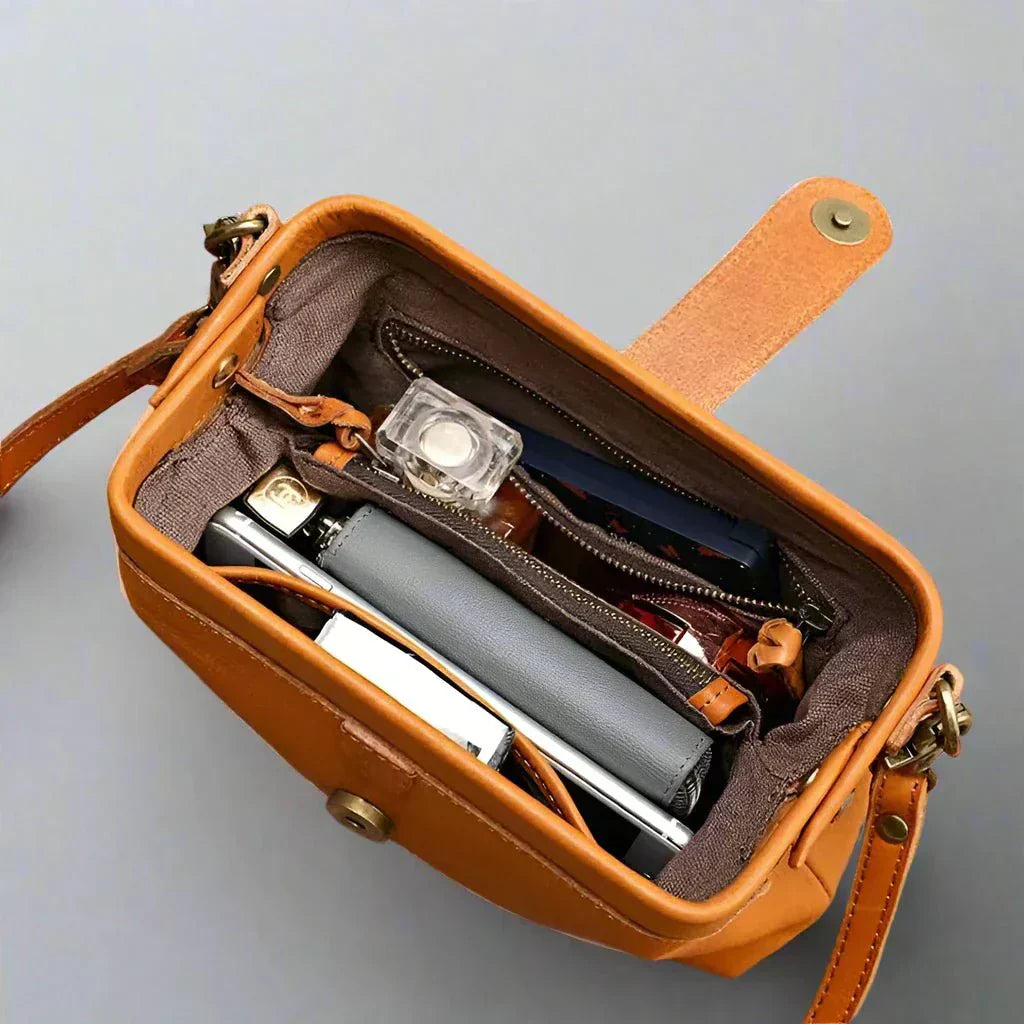 Eclipse Charm refined leather shoulder bag with vintage-inspired frame closure and copper clasp